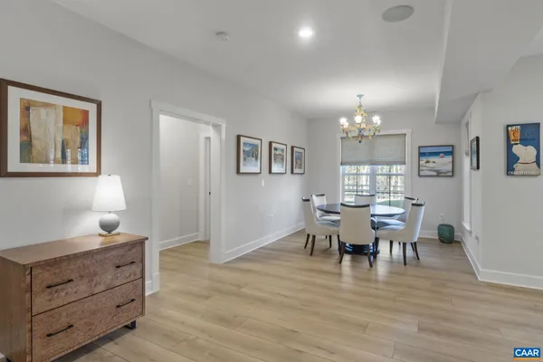 a view of a dining room with furniture and wooden floor
