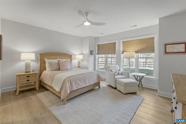 a bedroom with a bed and large window