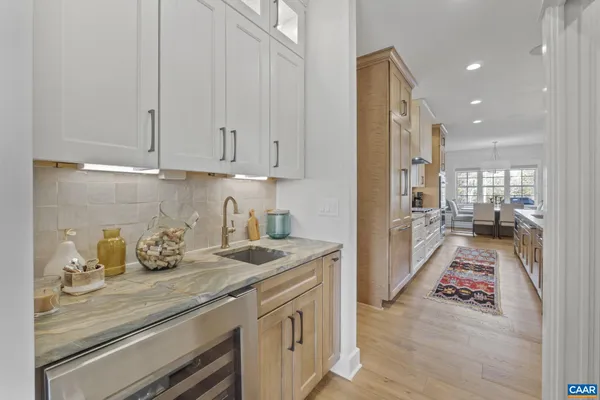 a kitchen with granite countertop a sink and dishwasher stove top oven