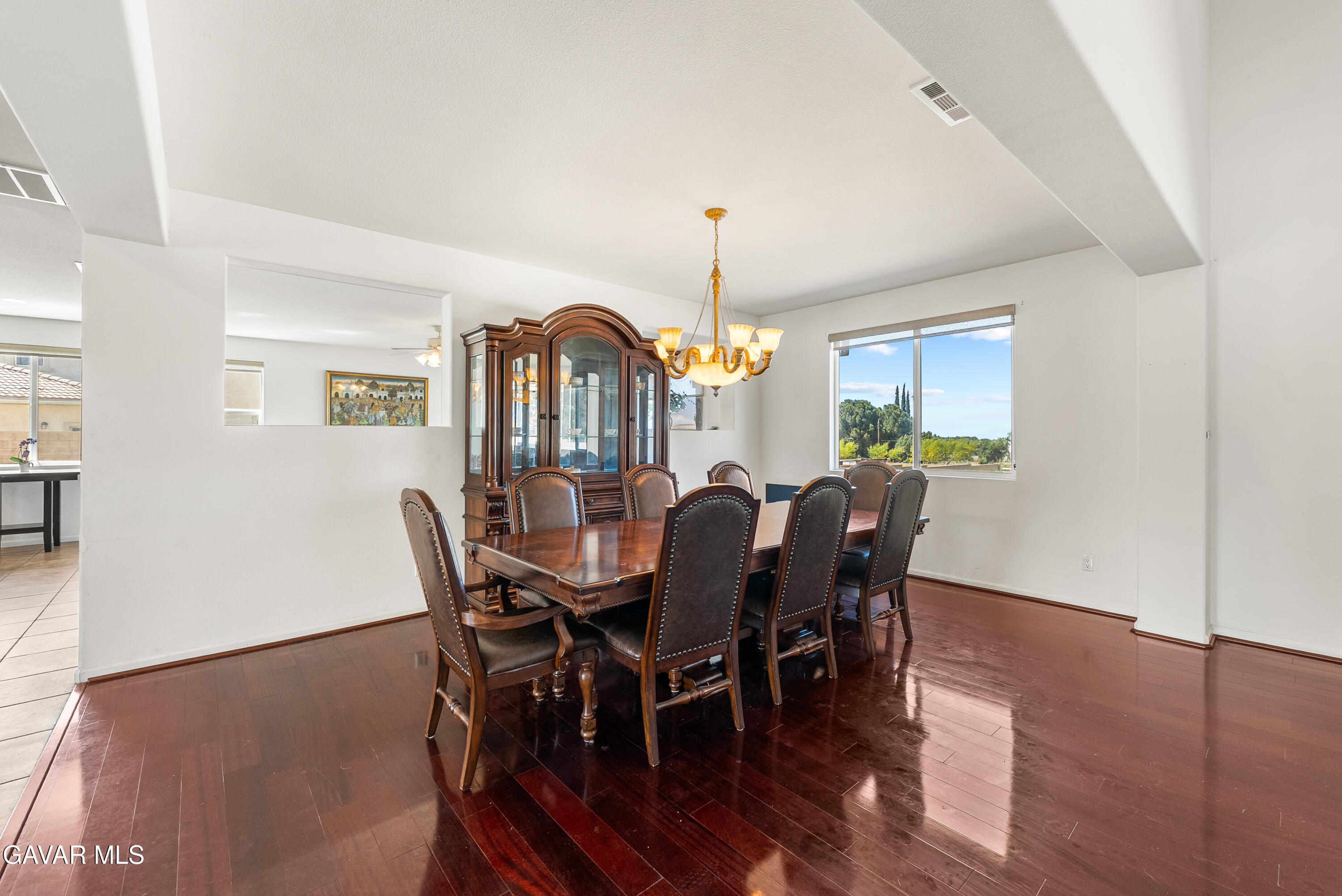 658 Lago Lindo Road Palmdale, CA 93550 - Photo 17 of 91 a view of a dining room with furniture window and wooden floor
