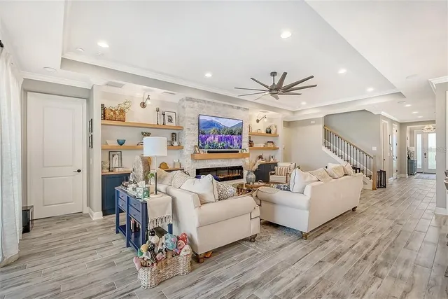 a kitchen with stainless steel appliances kitchen island granite countertop a dining table chairs and white cabinets