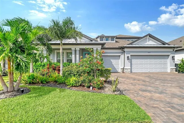 a front view of a house with a garden and plants