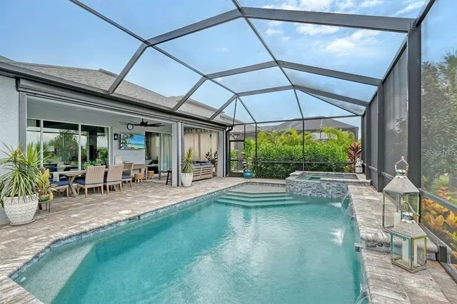 a view of a patio with table and chairs under an umbrella