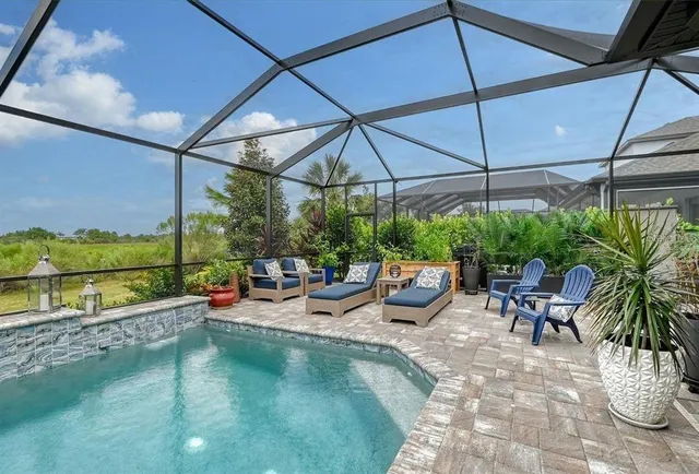a living room with furniture a table and a large window