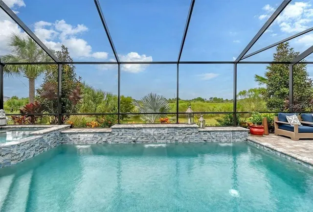 an aerial view of a house with a garden and lake view