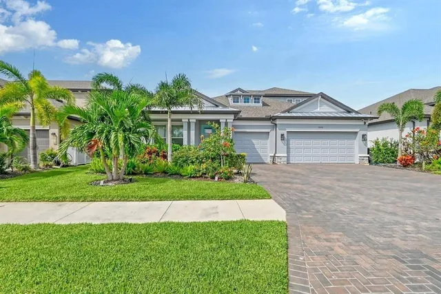 a front view of a house with a garden and plants
