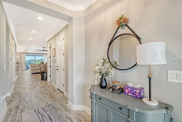 a living room with furniture a flat screen tv and a large window
