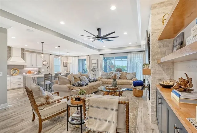 a living room with lots of furniture and view of kitchen