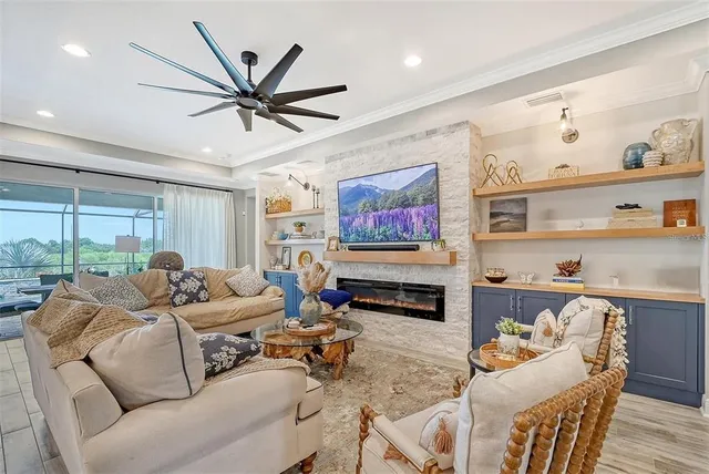 a view of a dining room and livingroom with furniture wooden floor a chandelier