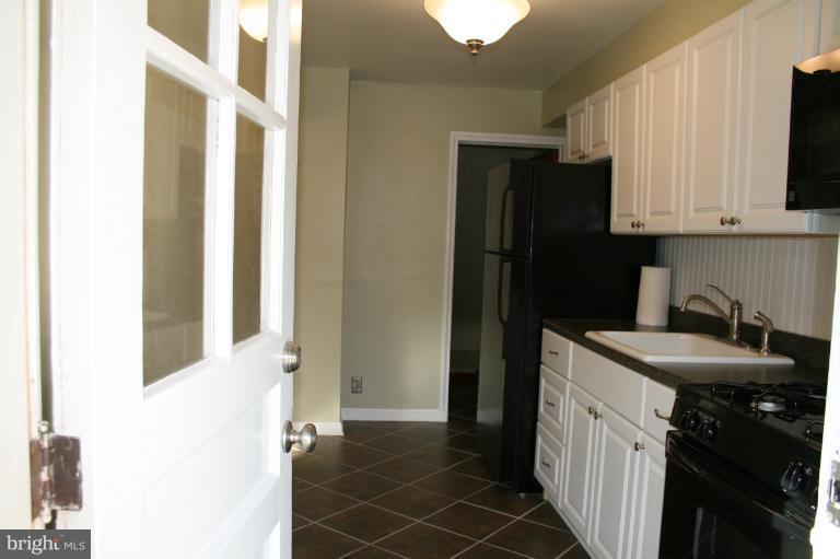 543 Larkfield Road Dundalk, MD 21222 - Photo 1 of 30 a kitchen with a sink and a refrigerator