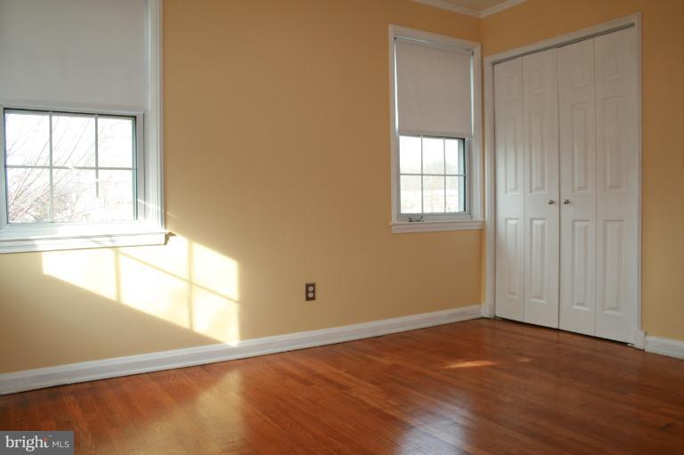 543 Larkfield Road Dundalk, MD 21222 - Photo 11 of 30 an empty room with wooden floor and windows