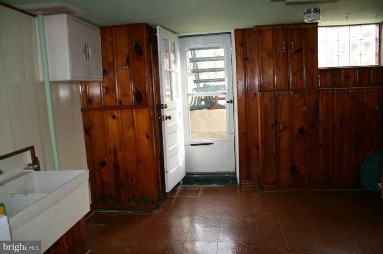 543 Larkfield Road Dundalk, MD 21222 - Photo 12 of 30 a view of a hallway with wooden cabinets