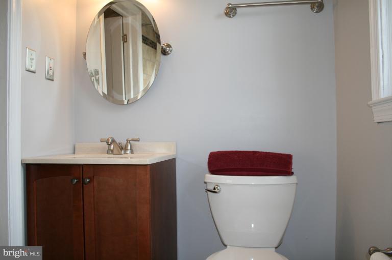 543 Larkfield Road Dundalk, MD 21222 - Photo 17 of 30 a bathroom with a toilet a sink and mirror