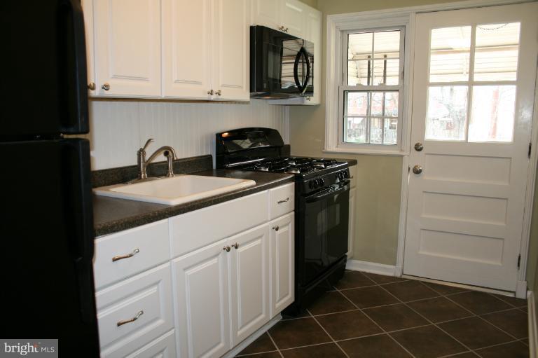 543 Larkfield Road Dundalk, MD 21222 - Photo 24 of 30 a kitchen with appliances cabinets and a window