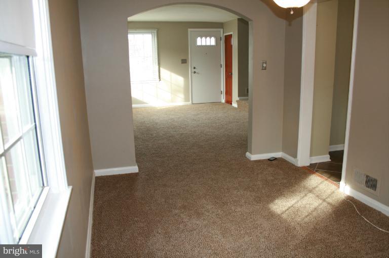 543 Larkfield Road Dundalk, MD 21222 - Photo 28 of 30 a view of a hallway with wooden floor and a livingroom