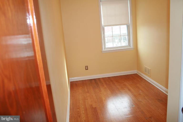 543 Larkfield Road Dundalk, MD 21222 - Photo 29 of 30 a view of an empty room with wooden floor and a window
