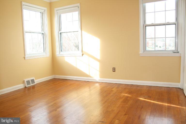 543 Larkfield Road Dundalk, MD 21222 - Photo 5 of 30 a view of an empty room with a window and wooden floor