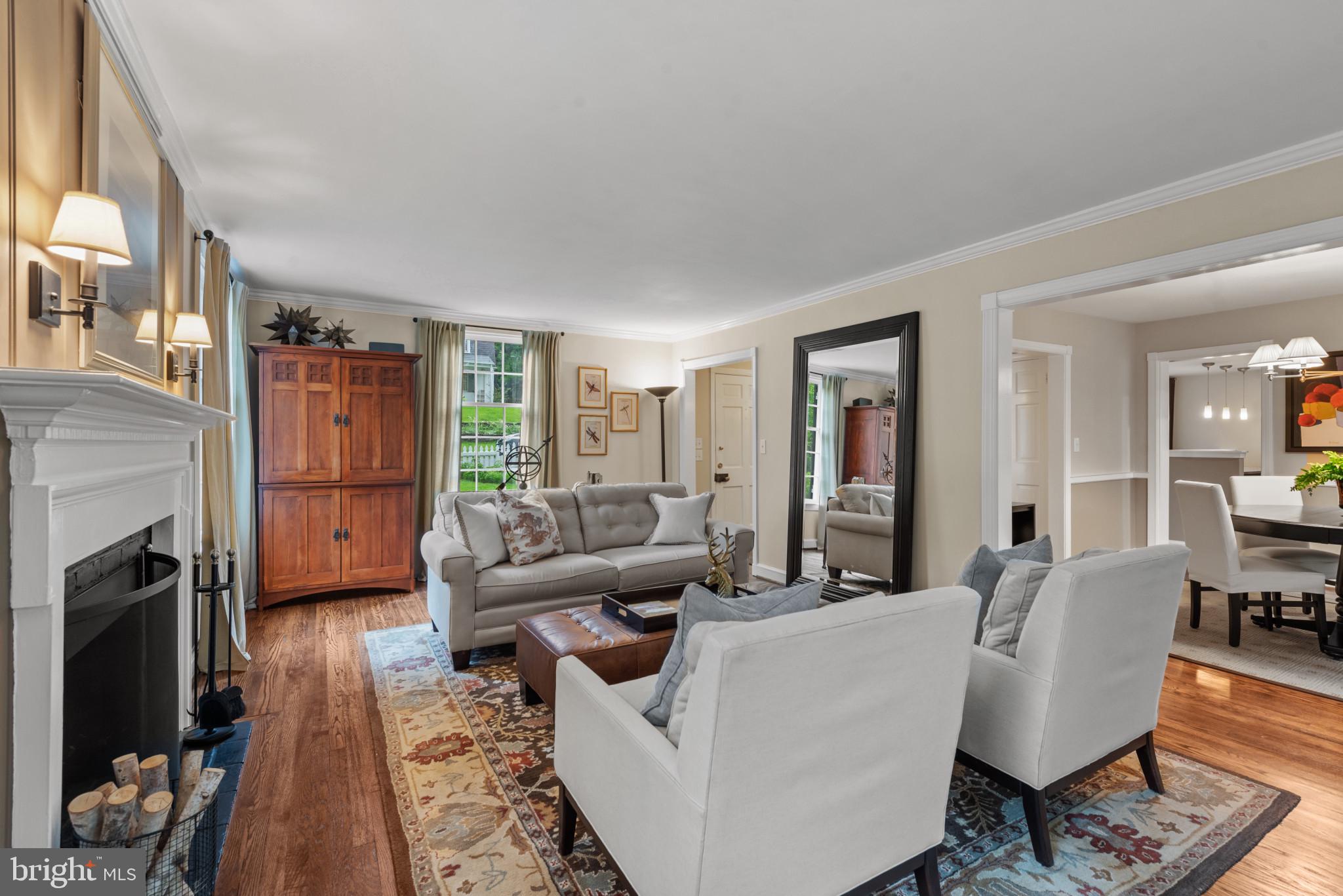 2443 Pickwick Road Baltimore, MD 21207 - Photo 11 of 108 a living room with fireplace furniture and a wooden floor