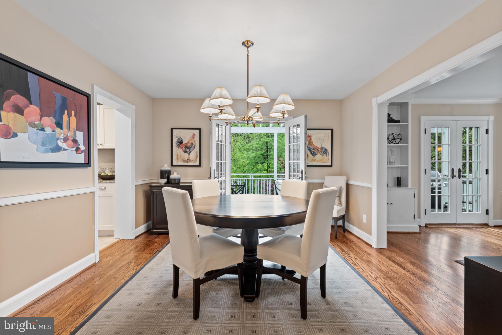 2443 Pickwick Road Baltimore, MD 21207 - Photo 19 of 108 a dining room with furniture a chandelier and wooden floor