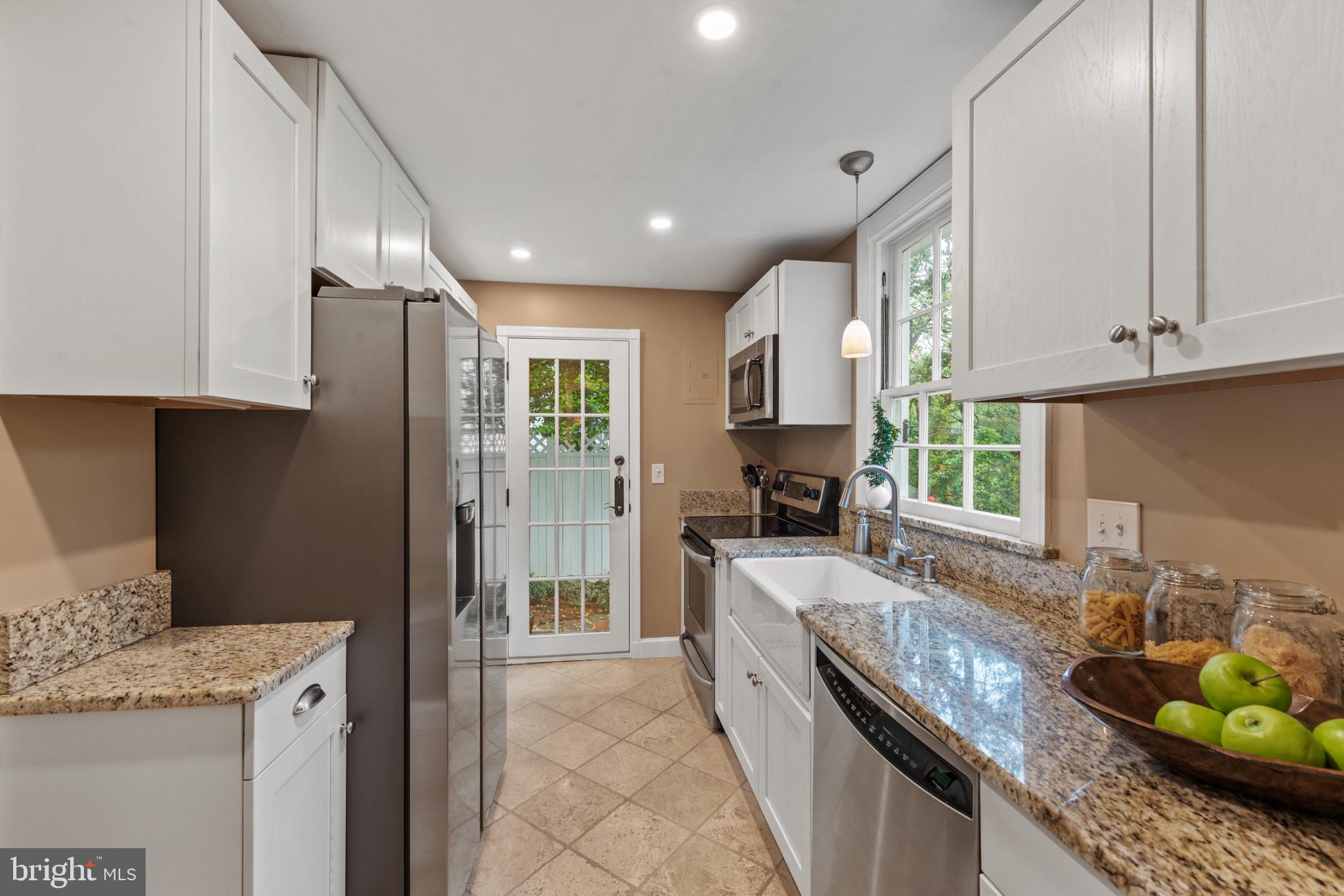 2443 Pickwick Road Baltimore, MD 21207 - Photo 22 of 108 a kitchen with granite countertop cabinets stainless steel appliances a sink and a counter top space