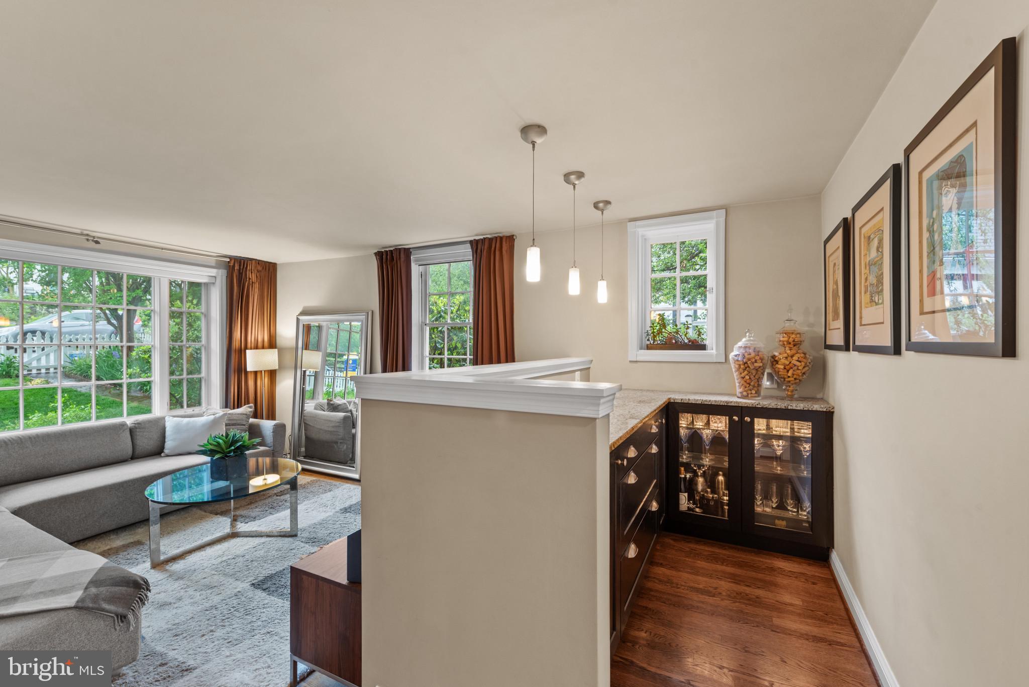 2443 Pickwick Road Baltimore, MD 21207 - Photo 24 of 108 a living room with furniture a large window and wooden floor