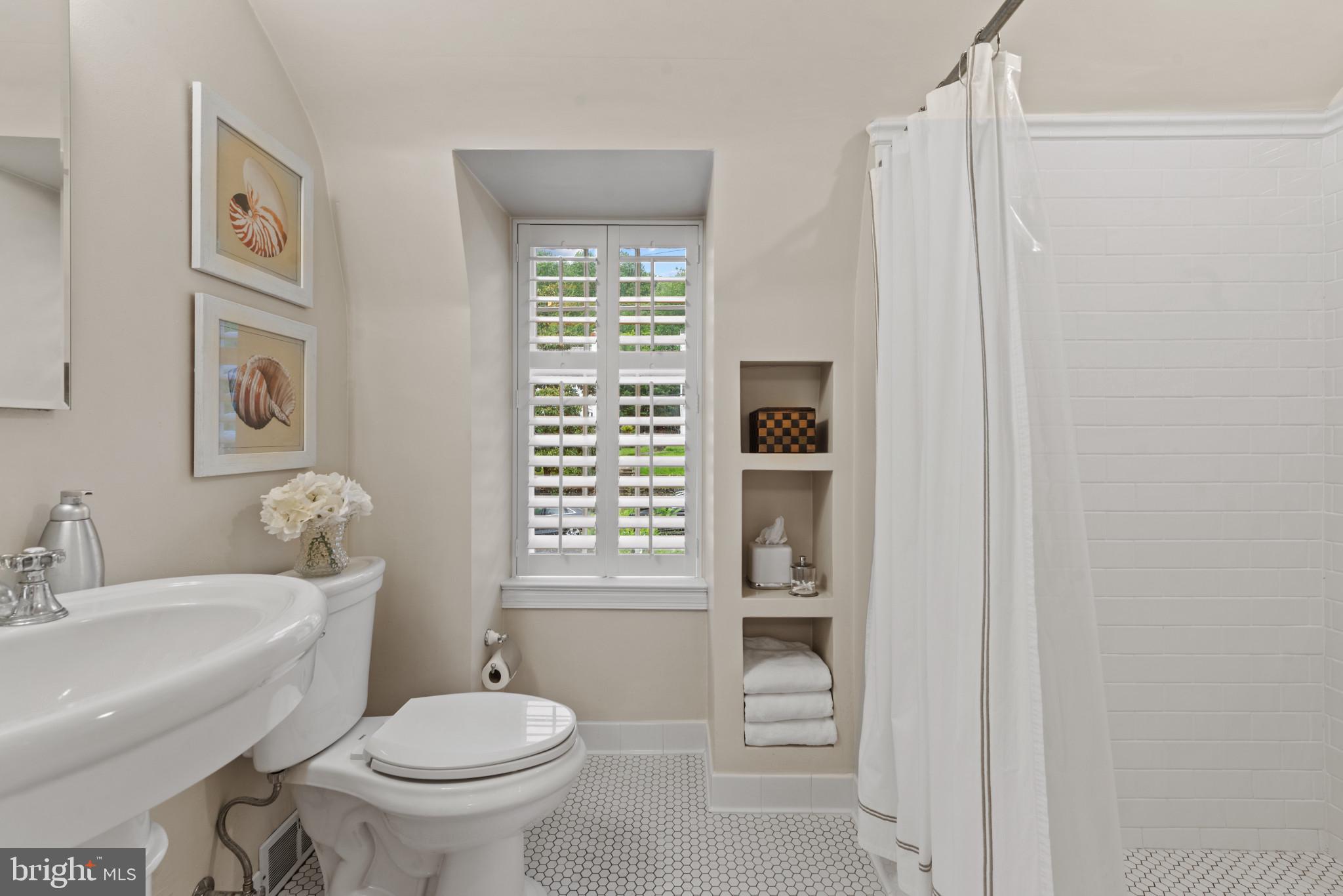 2443 Pickwick Road Baltimore, MD 21207 - Photo 32 of 108 a bathroom with a toilet a sink and a mirror