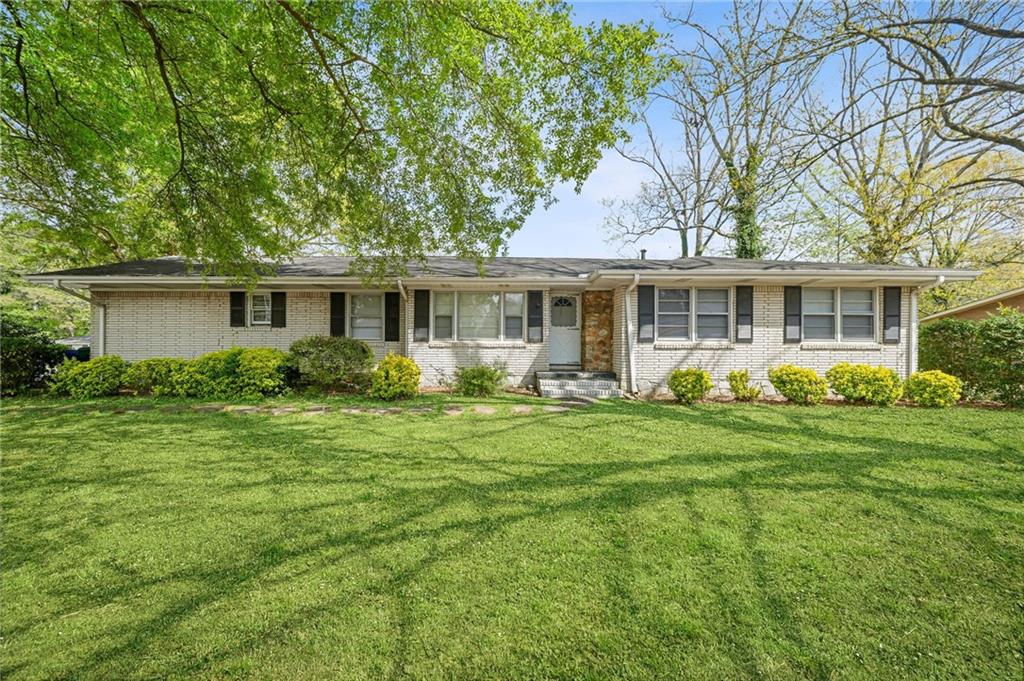 a front view of house with yard and green space