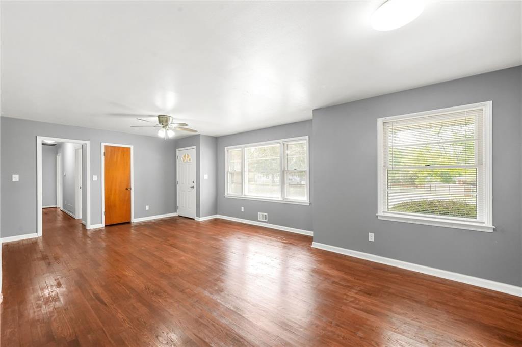 1393 Idlewood Road Tucker, GA 30084 - Photo 12 of 32 an empty room with wooden floor and windows