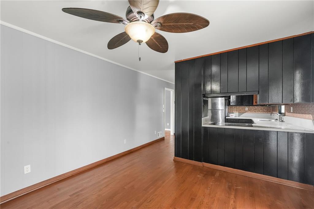 1393 Idlewood Road Tucker, GA 30084 - Photo 15 of 32 a kitchen with kitchen island stainless steel appliances a refrigerator and a stove top oven