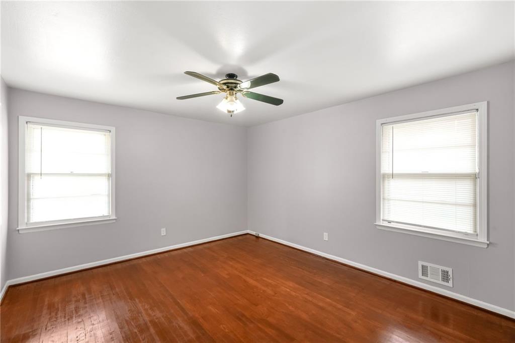 1393 Idlewood Road Tucker, GA 30084 - Photo 16 of 32 an empty room with a window and a fan