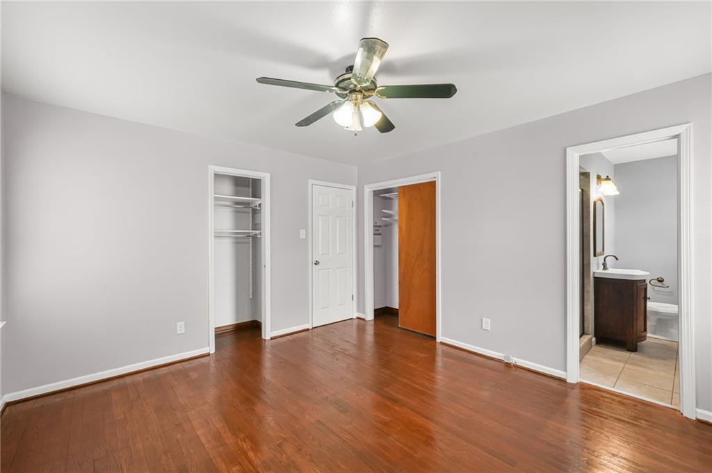 1393 Idlewood Road Tucker, GA 30084 - Photo 17 of 32 a view of an empty room with wooden floor and a ceiling fan