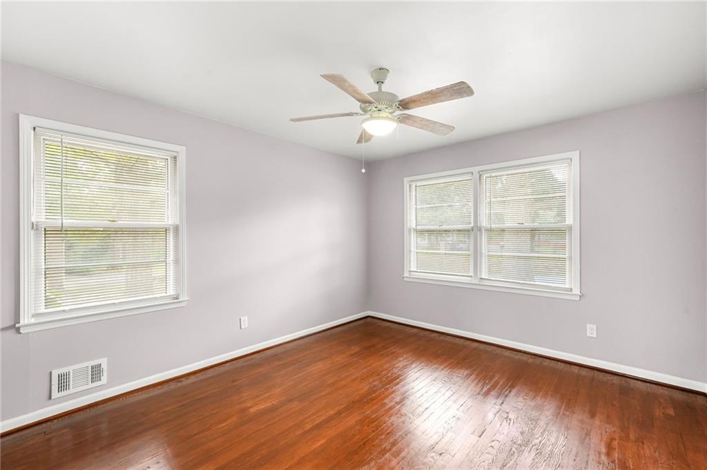 1393 Idlewood Road Tucker, GA 30084 - Photo 19 of 32 a view of an empty room with wooden floor and a window