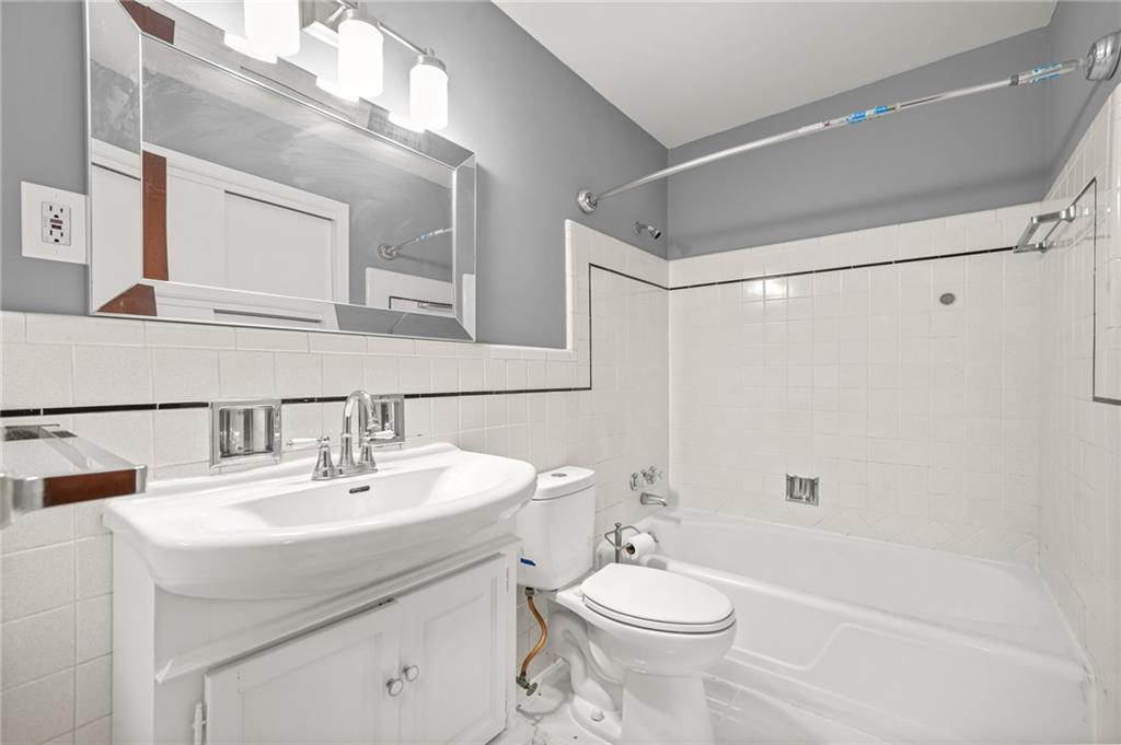 1393 Idlewood Road Tucker, GA 30084 - Photo 21 of 32 a bathroom with a sink a toilet and shower