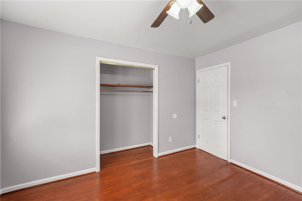 1393 Idlewood Road Tucker, GA 30084 - Photo 23 of 32 an empty room with ceiling fan and window