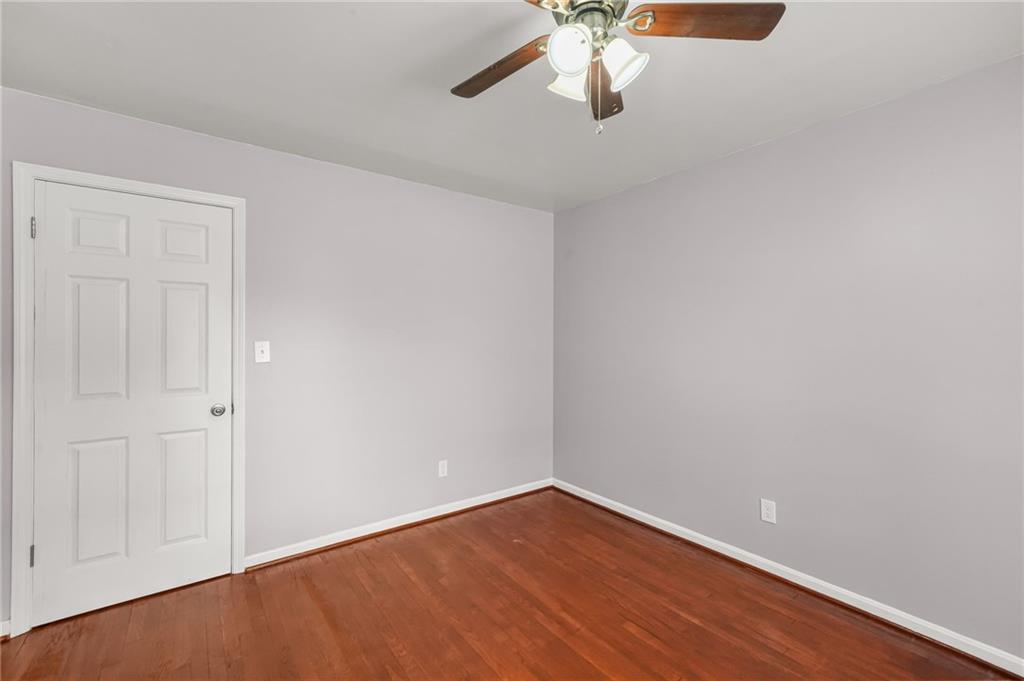 1393 Idlewood Road Tucker, GA 30084 - Photo 24 of 32 a view of an empty room with a chandelier fan