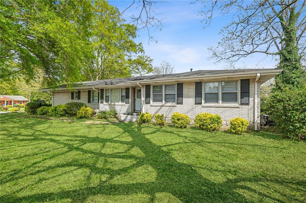 1393 Idlewood Road Tucker, GA 30084 - Photo 3 of 32 front view of a house with a yard