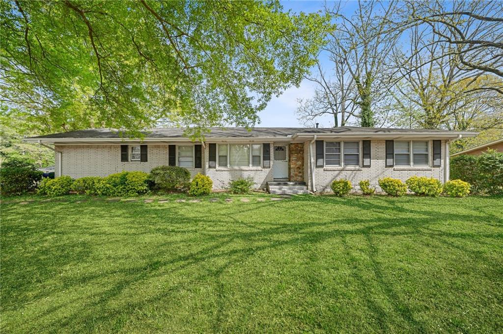 1393 Idlewood Road Tucker, GA 30084 - Photo 5 of 32 a front view of house with yard and green space