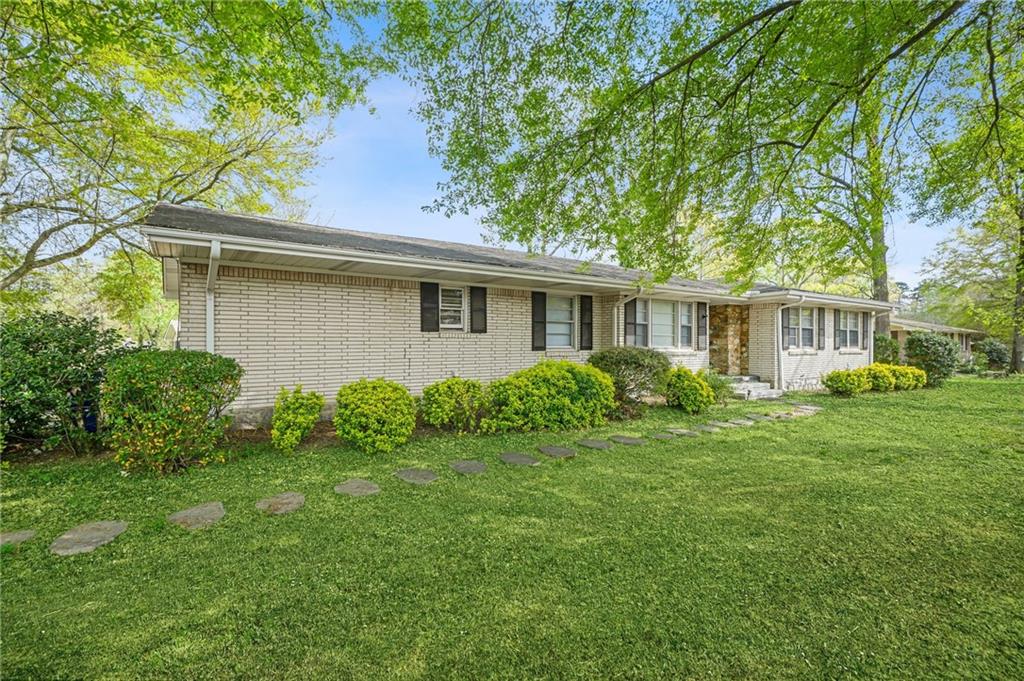 1393 Idlewood Road Tucker, GA 30084 - Photo 7 of 32 a house that is sitting in the grass