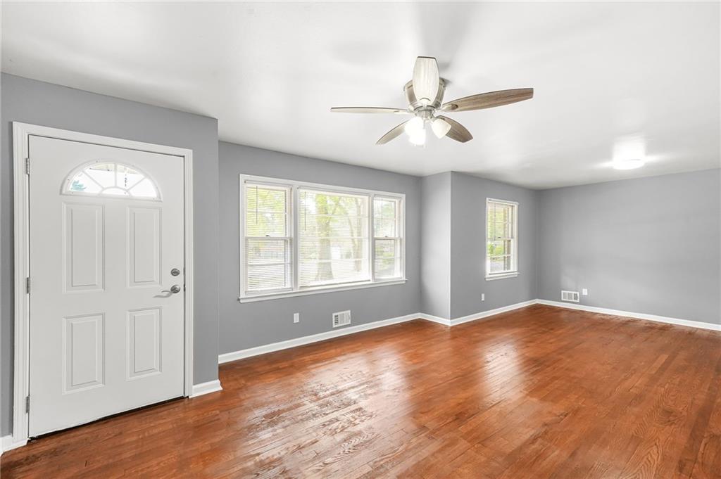 1393 Idlewood Road Tucker, GA 30084 - Photo 9 of 32 a view of an empty room with a window and wooden floor