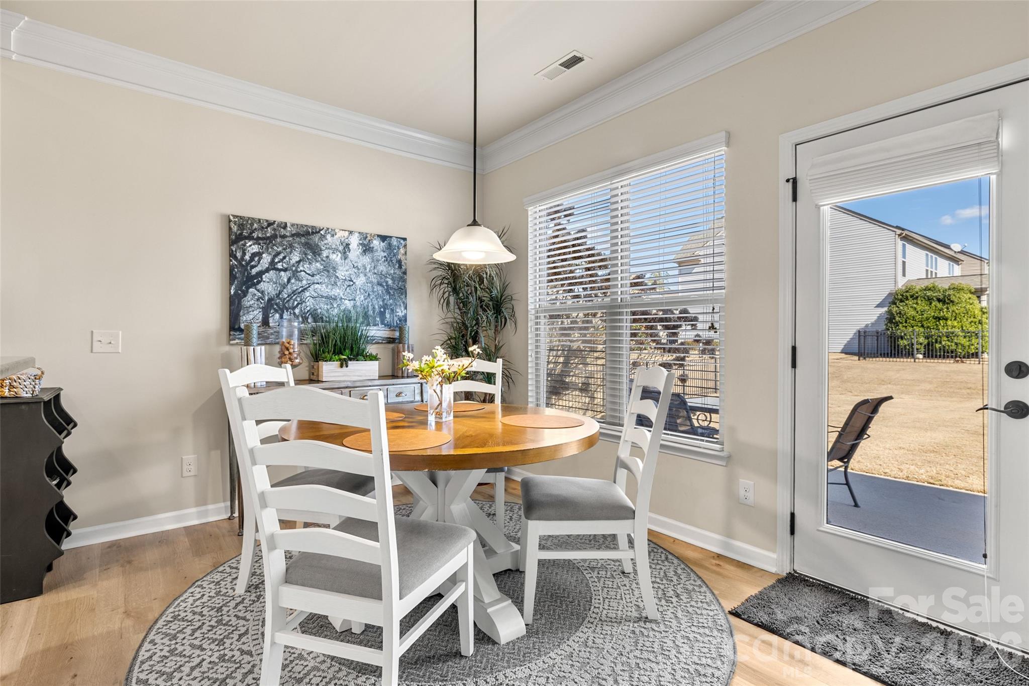 3534 Jumprock Road Fort Mill, SC 29707 - Photo 15 of 36 a dining room with furniture a chandelier and window