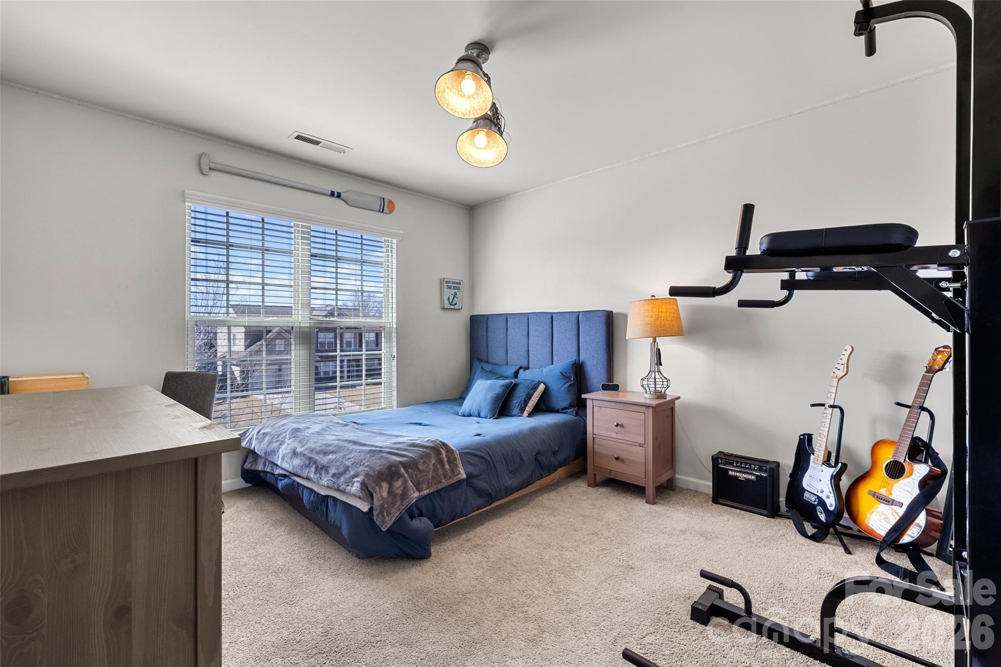 3534 Jumprock Road Fort Mill, SC 29707 - Photo 23 of 36 a bedroom with a bed and a chandelier