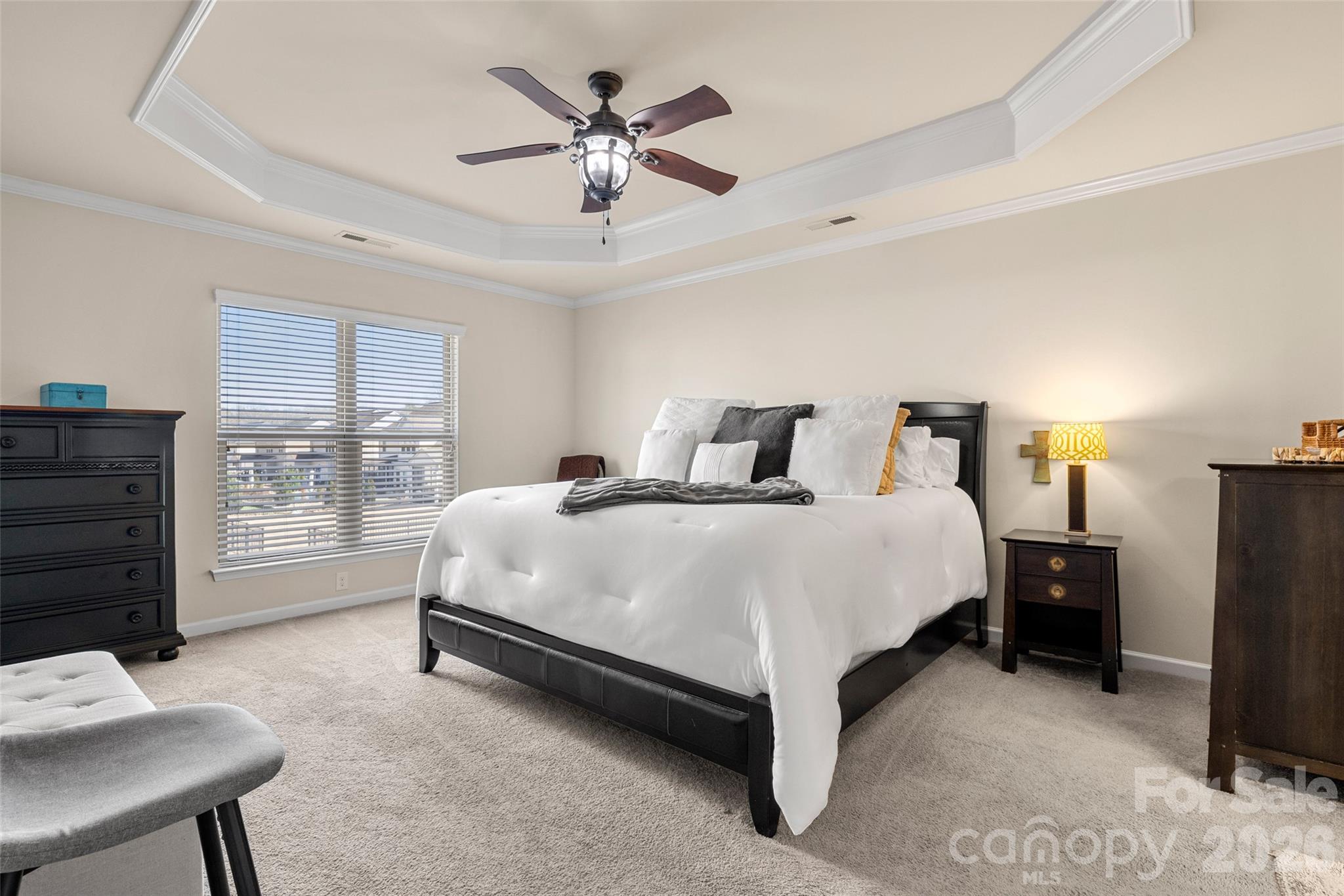 3534 Jumprock Road Fort Mill, SC 29707 - Photo 25 of 36 a spacious bedroom with a bed a chandelier and a window