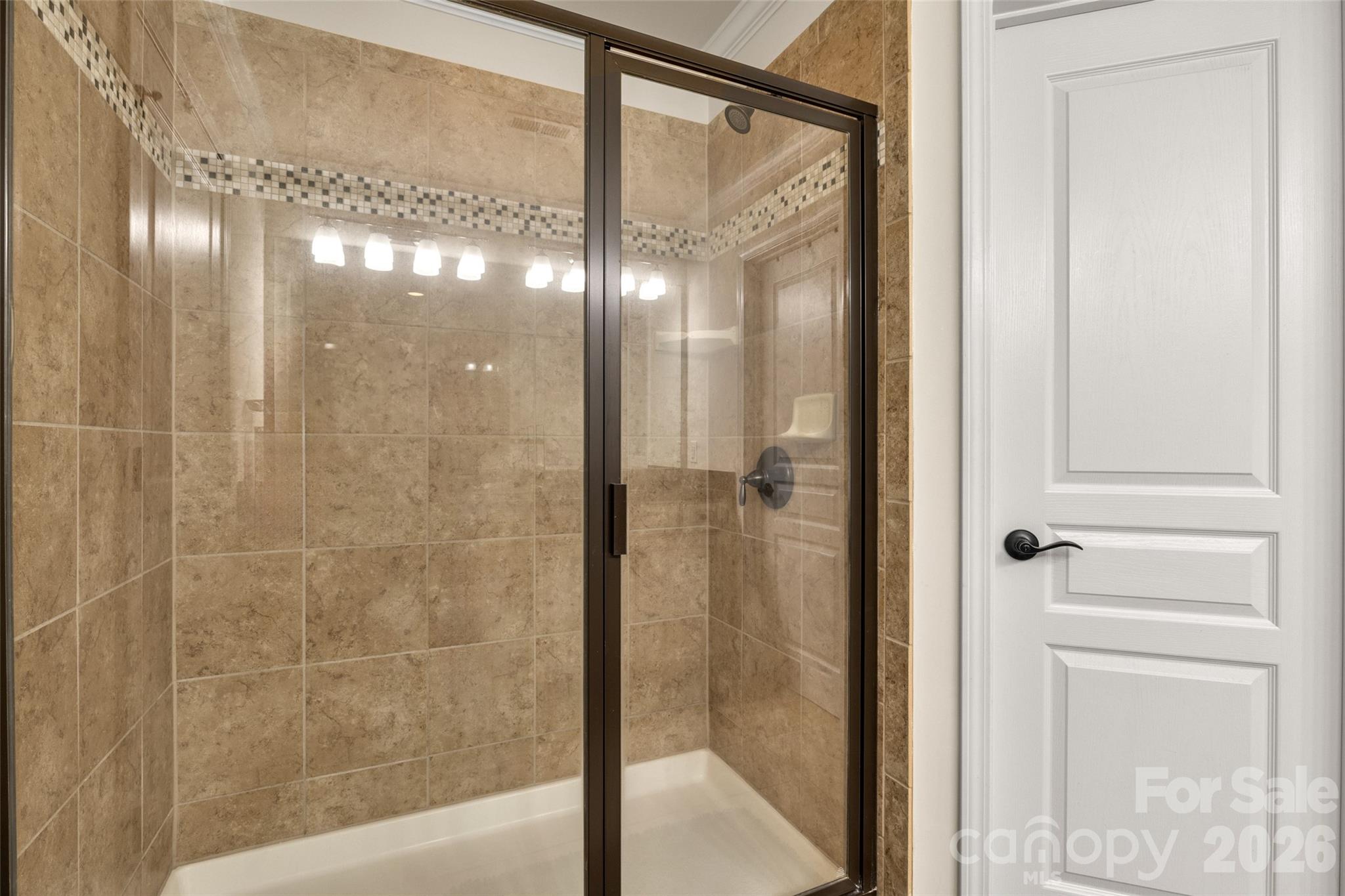 3534 Jumprock Road Fort Mill, SC 29707 - Photo 28 of 36 a bathroom with a glass shower door