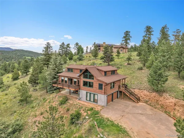 a aerial view of a house with a yard and balcony