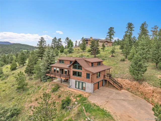 a aerial view of a house with a yard and balcony