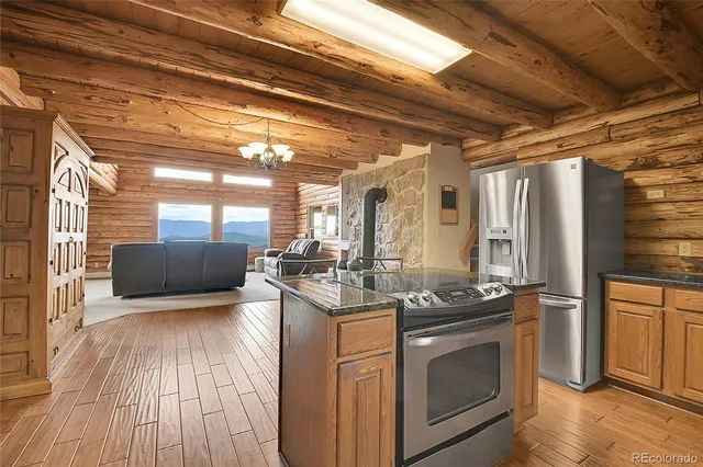 a kitchen with stainless steel appliances granite countertop a stove and a refrigerator