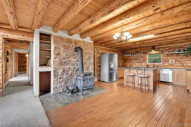 a view of a livingroom with furniture and kitchen
