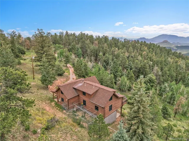 an aerial view of a house with mountain view