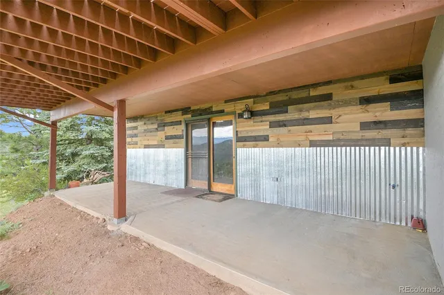 a view of outdoor space with wooden floor and windows