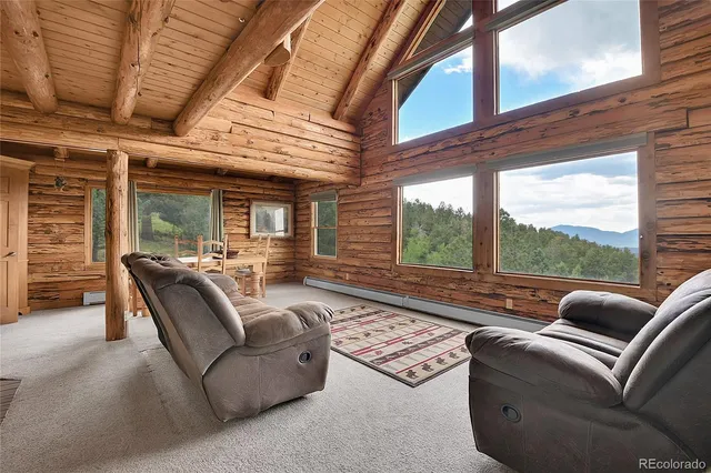a living room with furniture floor to ceiling window